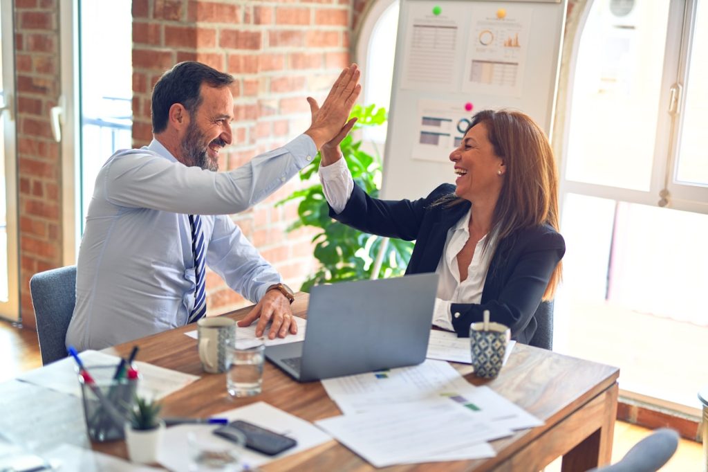 Agency owners agreeing a white label PPC partnership for reselling paid media management