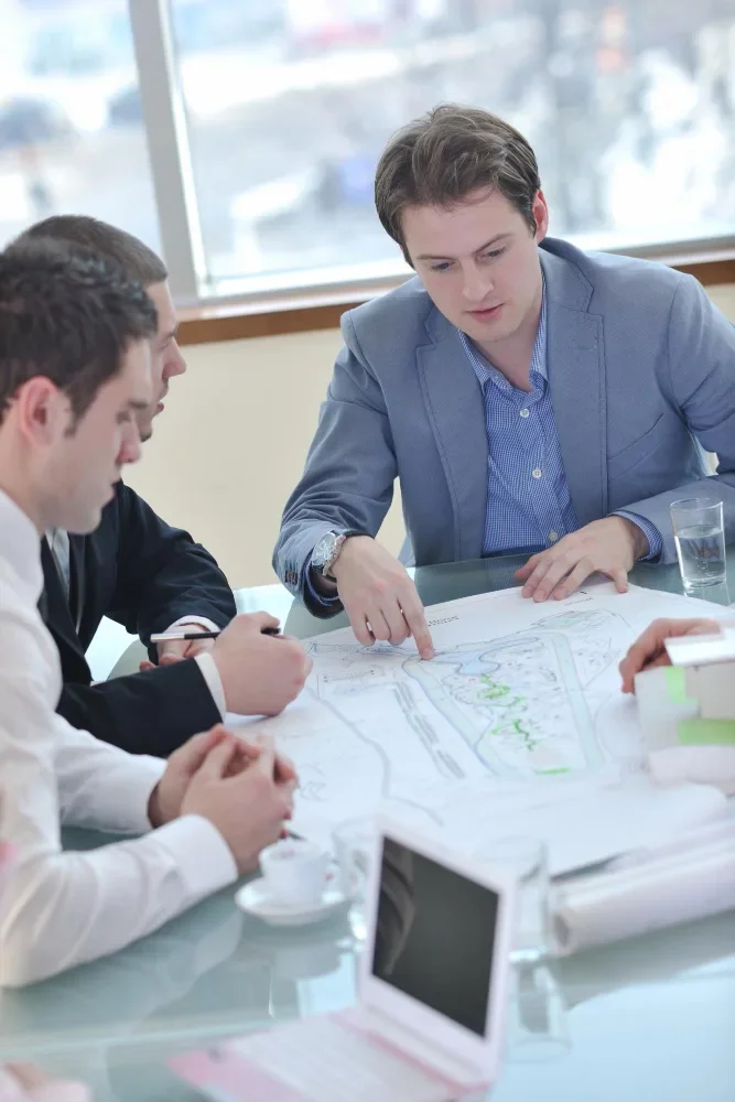 Developer coding a responsive website layout on a laptop